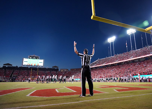 https://unsplash.com/photos/a-football-player-standing-on-a-field-with-his-arms-in-the-air-zZgq0_SqPtU